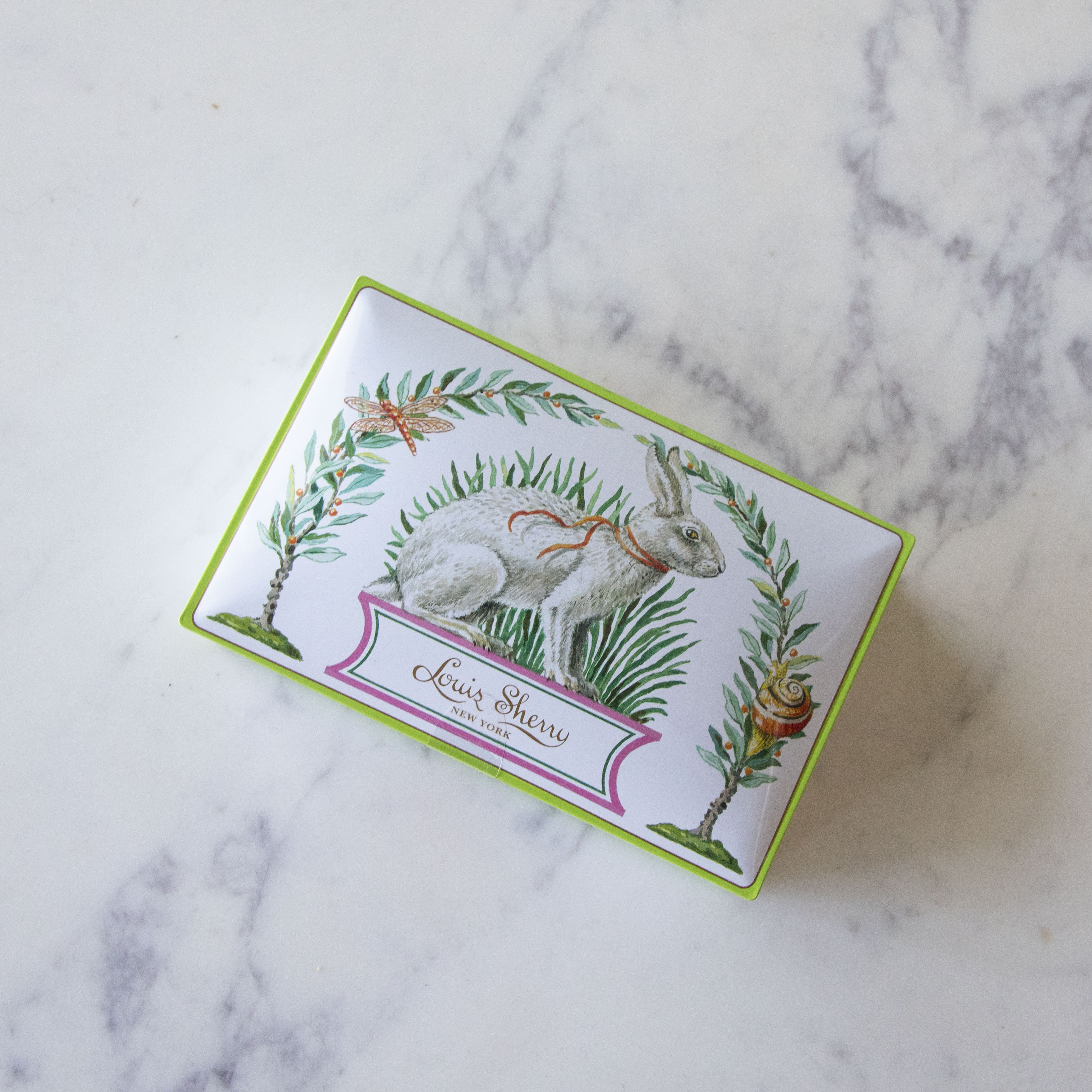 12-Piece Harrison Howard Bunny Rabbit Louis Sherry Chocolate Box on a marble table.