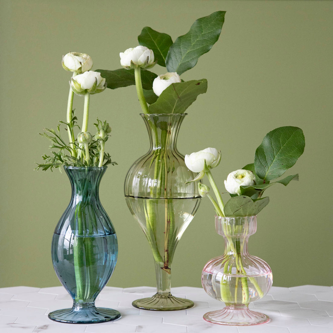 A Blue Vintage Boutique Vase by Accent Decor sitting on top of a table.