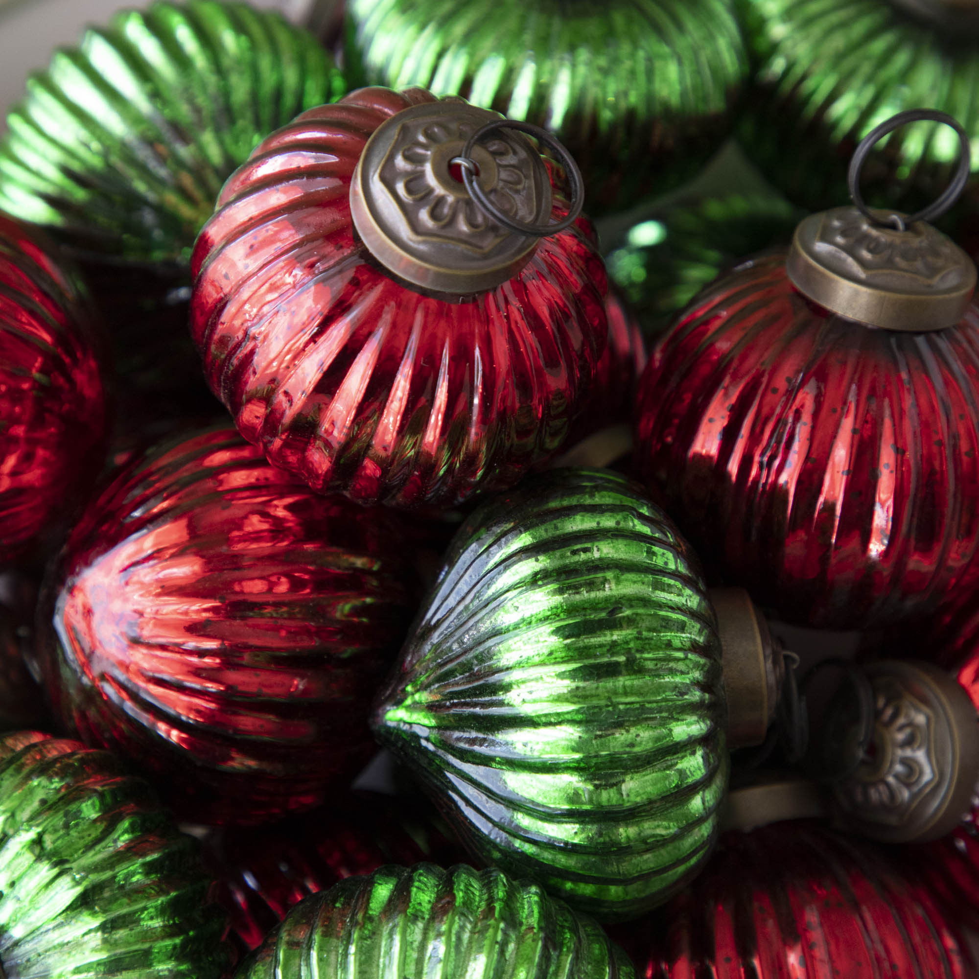 Close up of red and green mini ribbed ornaments together.