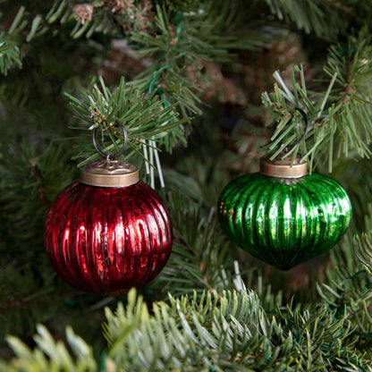 Mini green and red ribbed ornaments on a tree.