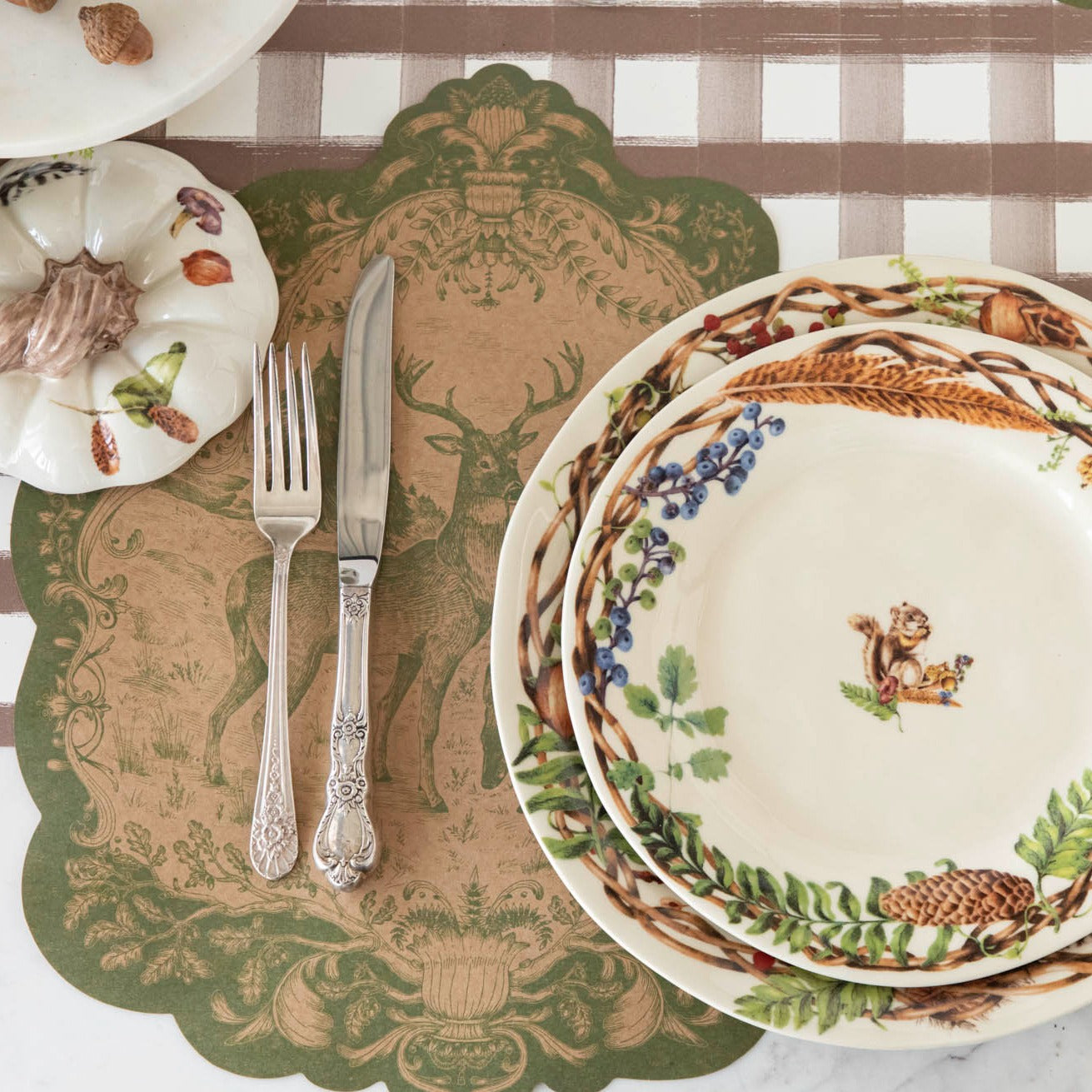 The Die-cut Moss Fable Fauna Placemat under an elegant place setting.