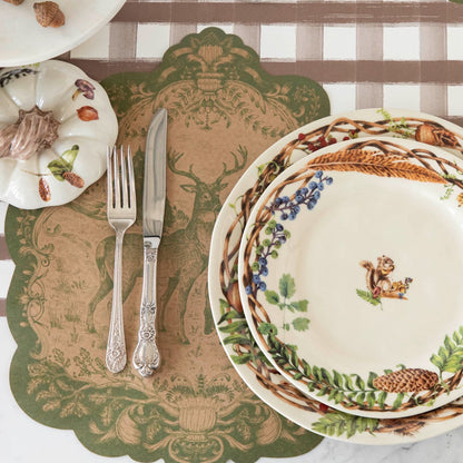 The Die-cut Moss Fable Fauna Placemat under an elegant place setting.