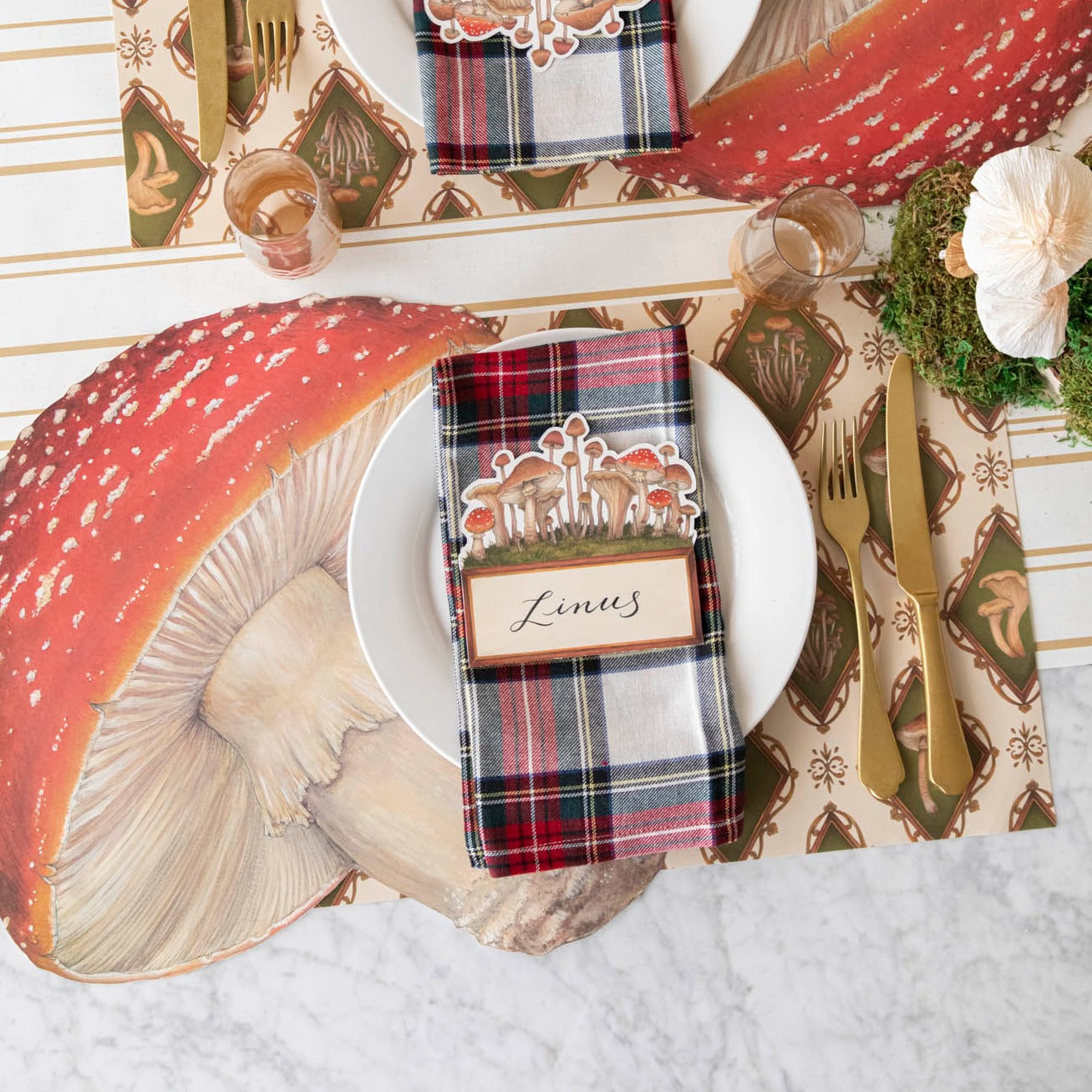Styled table setting with mushroom placemats and place card on a napkin