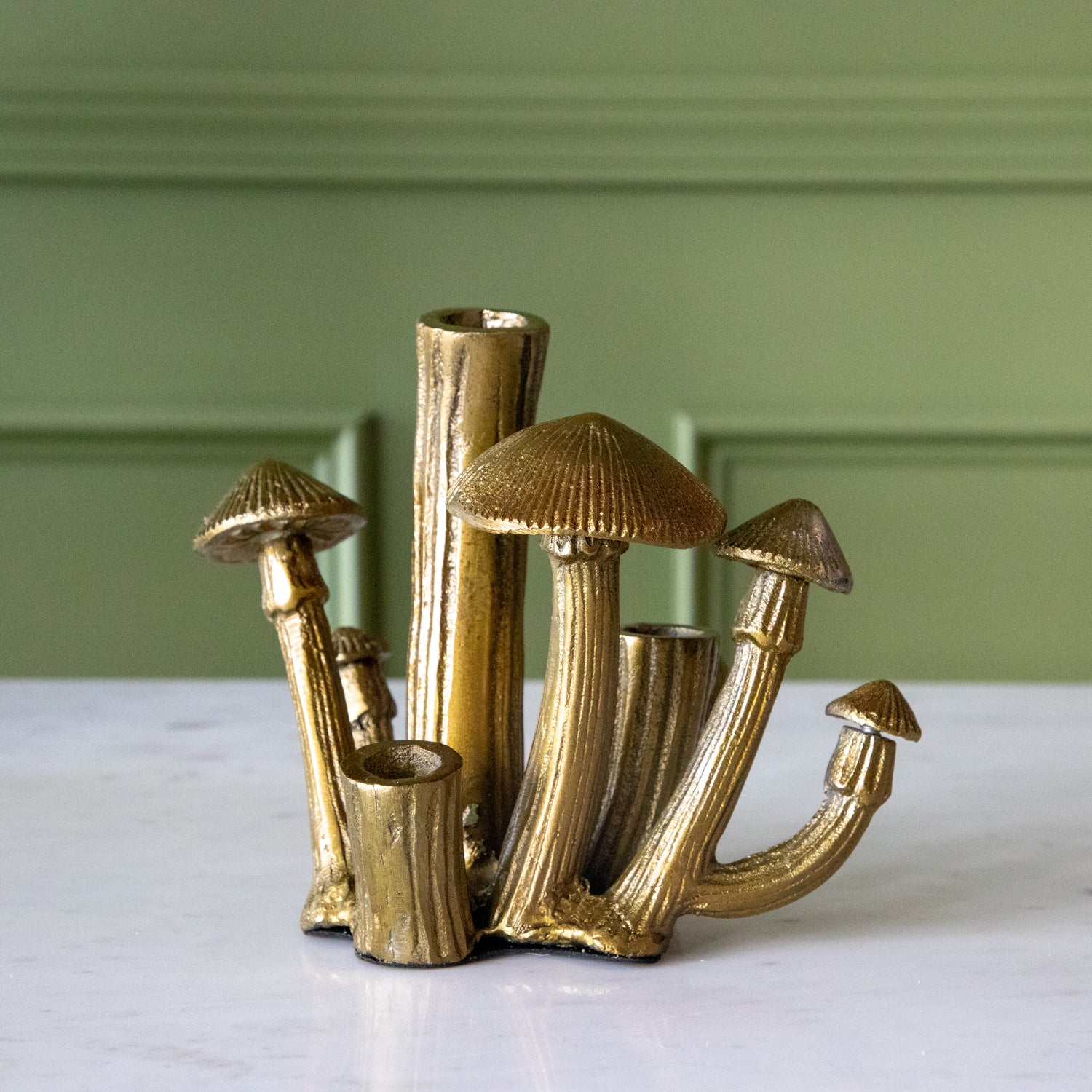 A Clustered Mushroom Budvase on a marble table.