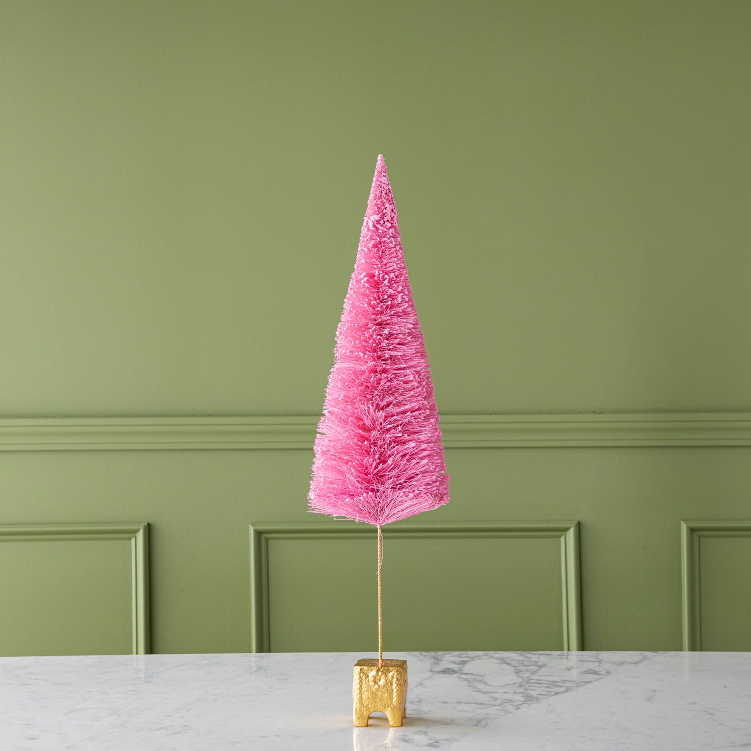 A 26&quot; Light Pink French Forest Sisal Tree with a gold base, on a marble table.