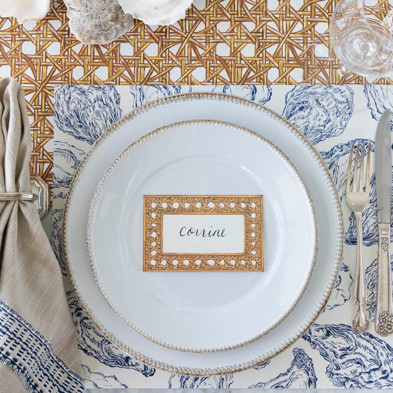 Blue Oyster Reef Placemat under a place setting on a sea themed table.