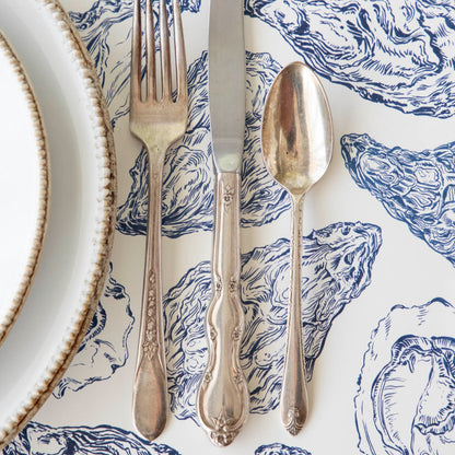 Close up of the Blue Oyster Reef Placemat under a place setting.