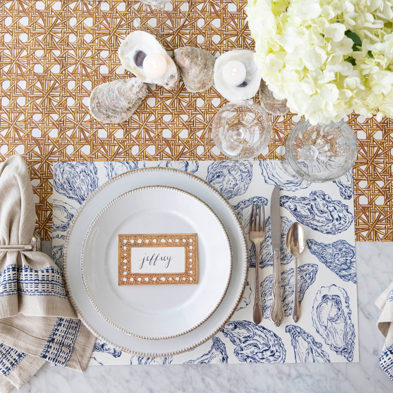 Blue Oyster Reef Placemat under a place setting on a sea themed table.