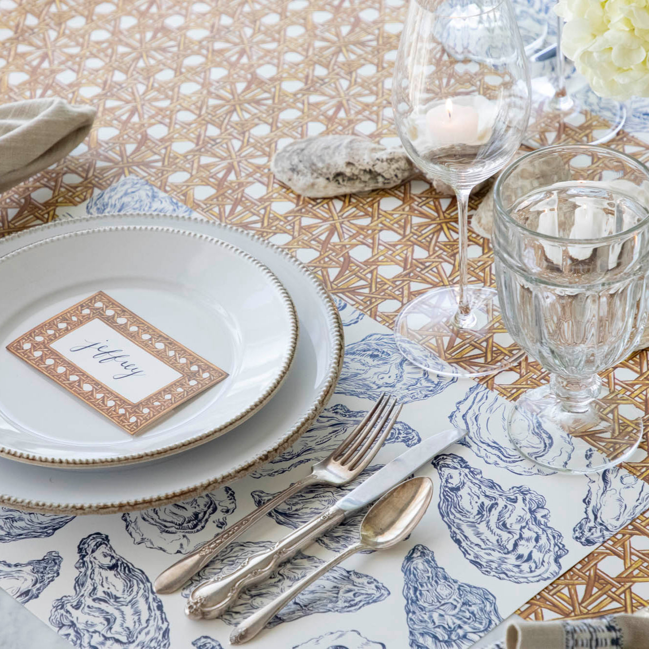 Blue Oyster Reef Placemat under an elegant place setting on a sea themed table.