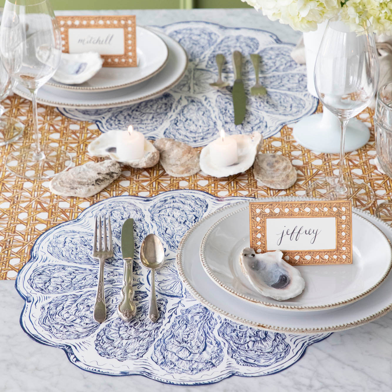 Die-cut Blue Oyster Plate Placemat under a place setting, on a sea themed table.