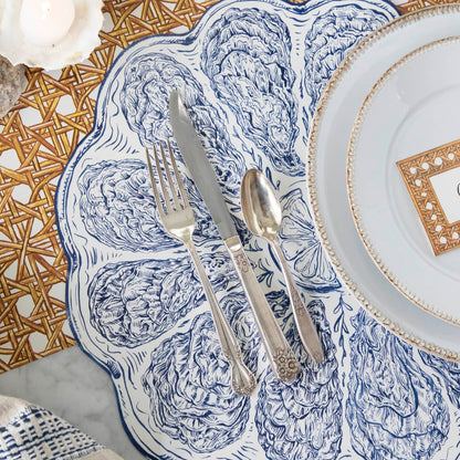 Die-cut Blue Oyster Plate Placemat under a place setting, on a sea themed table.