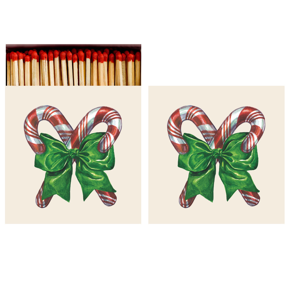 Two identical sides of a square match box, the left of which is open slightly to reveal the matches inside. The artwork on the box depicts two vintage-style red and white striped candy canes crossed at a diagonal, tied together with a green bow, on a cream background.