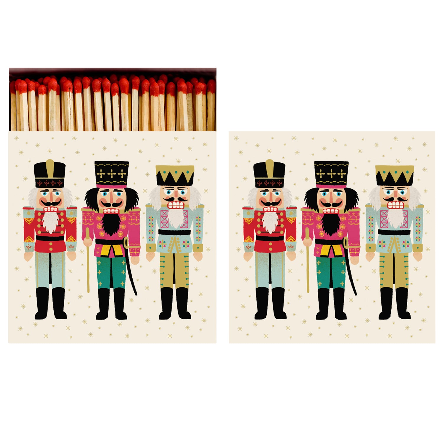 Two identical sides of a square match box, the left of which is open slightly to reveal the matches inside. The artwork on the box depicts three different toy soldier nutcrackers on a cream background sprinkled with gold snowflakes. 