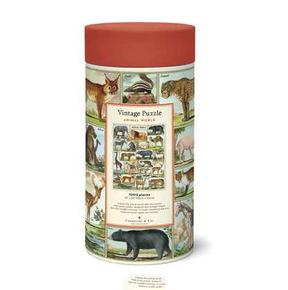 A cylindrical puzzle box with a vintage design, labeled &quot;Cavallini Papers &amp; Co Animal World Puzzle,&quot; featuring illustrated images of various animals.