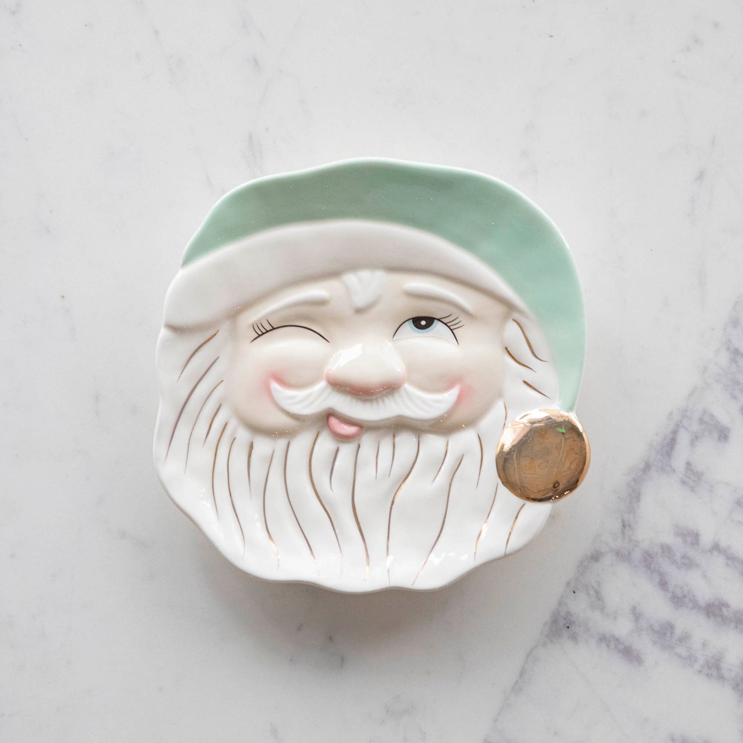 Papa Noel Mint Cookie Plate with one eye closed, a jolly face, and a mint hat with a gold painted pom.