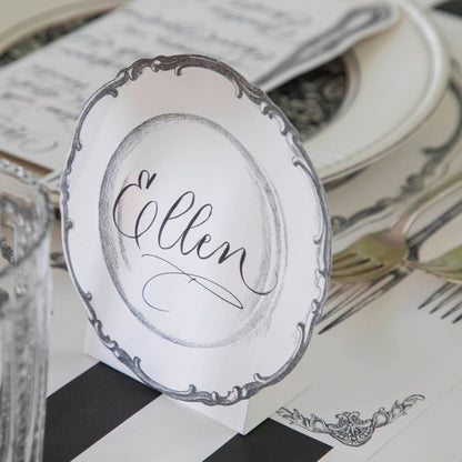 Vintage Plate Place Card with &quot;Ellen&quot; written on it, behind a place setting for one.