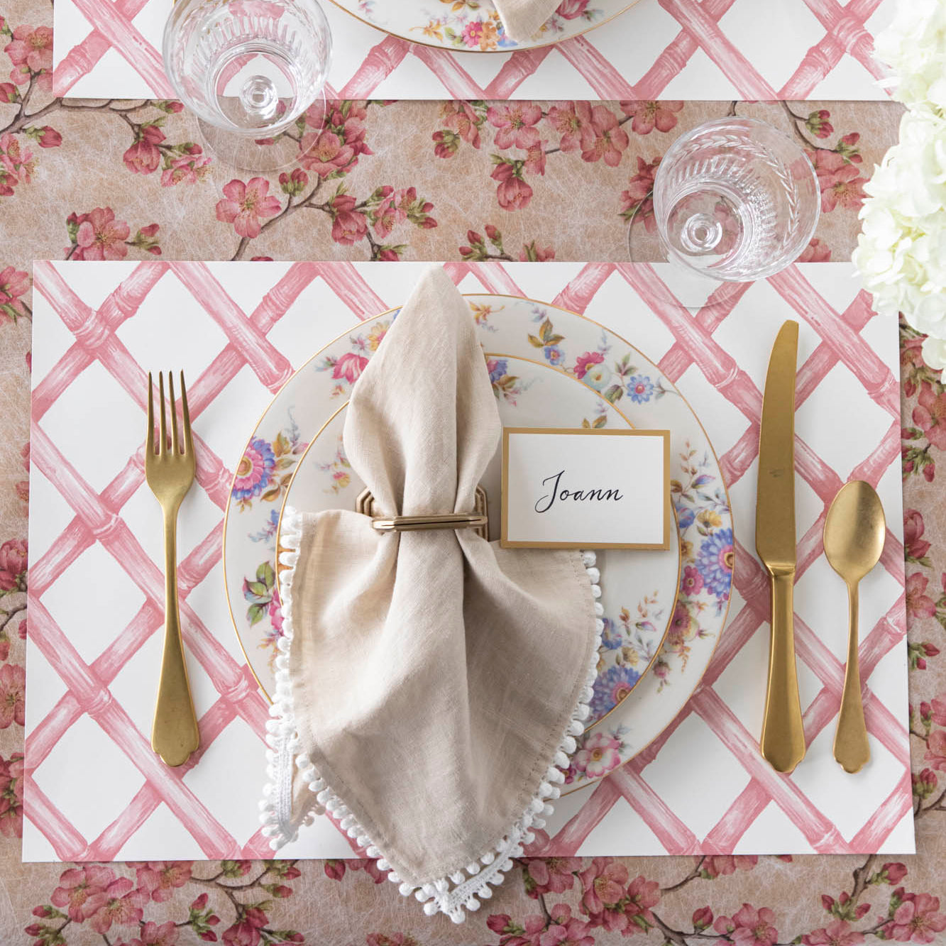 Pink Lattice Placemat on the Pink Cherry Blossom Runner and a spring themed place setting on top.