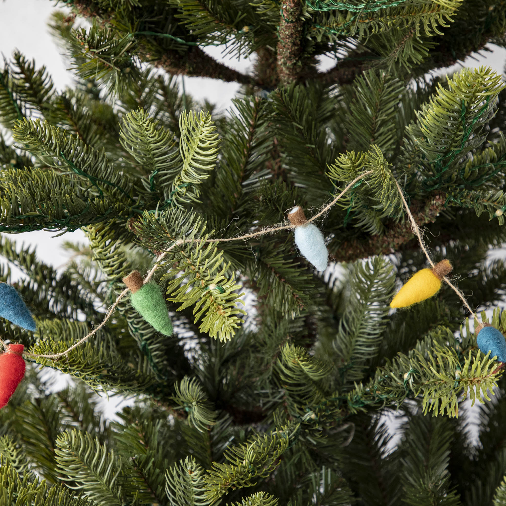 Felt String of Lights draped on a tree.