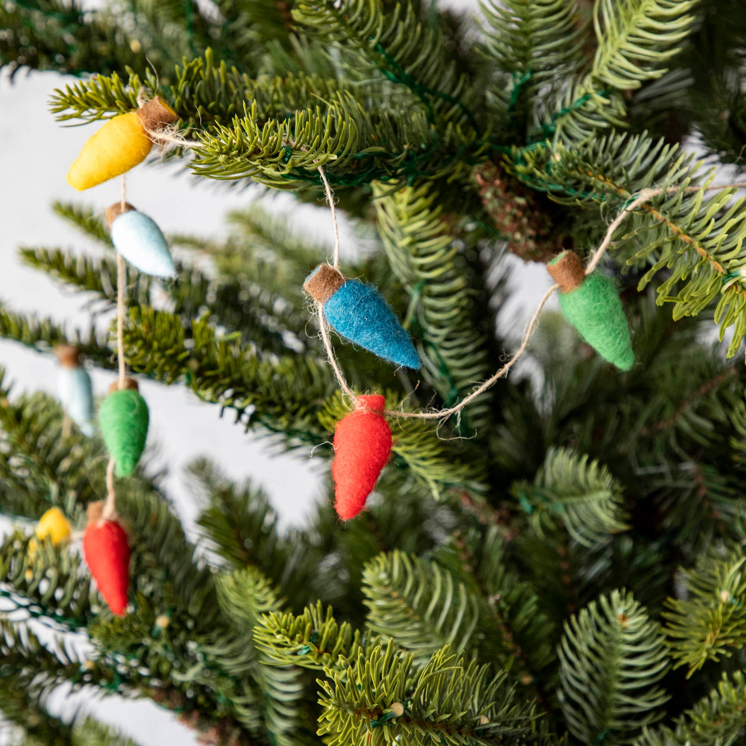 Felt String of Lights draped on a tree.