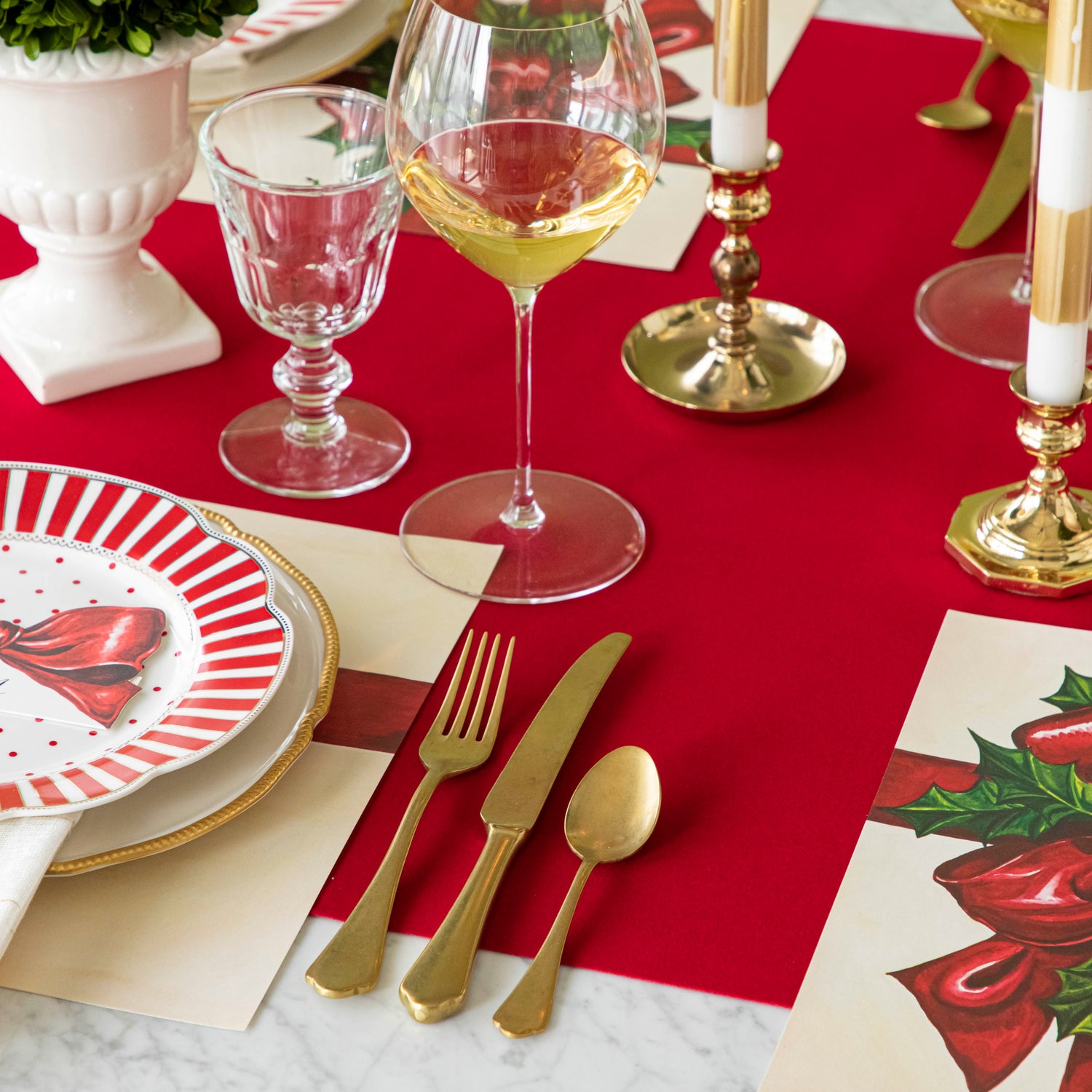 An elegant, Christmas themed table setting with the Red Flocked Runner underneath.