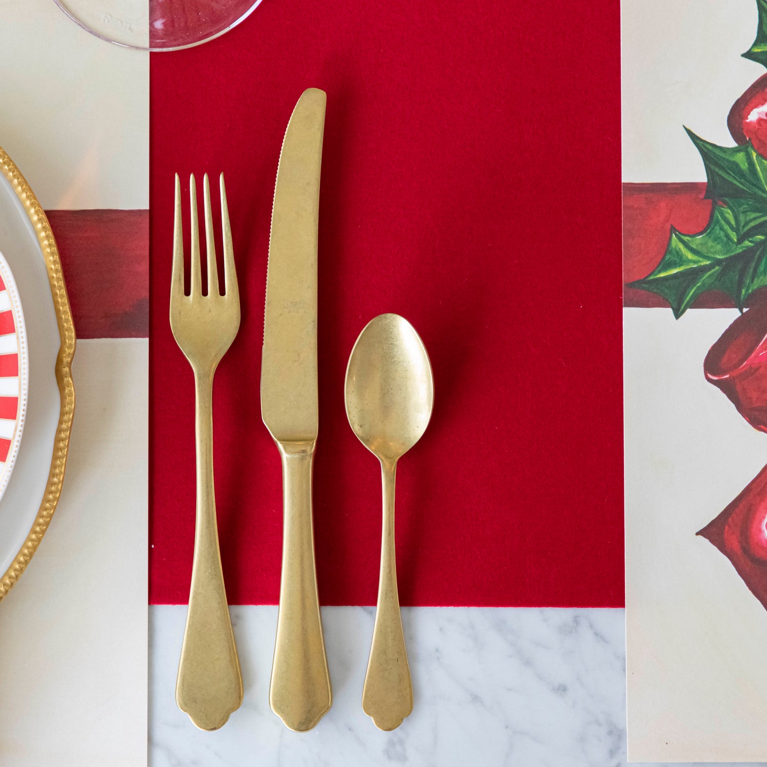 Vintage gold silverware on top of the Red Flocked Runner.