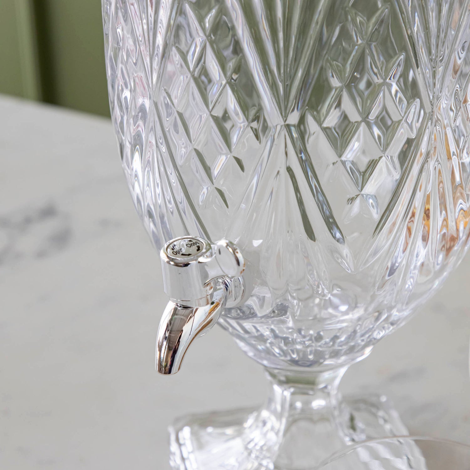 A close up of the Dublin Glass Beverage Dispenser pourer.