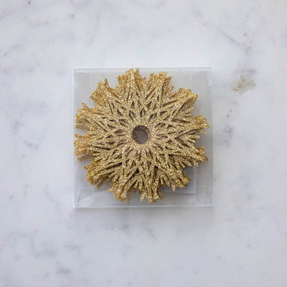 A Stemware Snowflake Collar Boxed Set of 8 on a marble table.