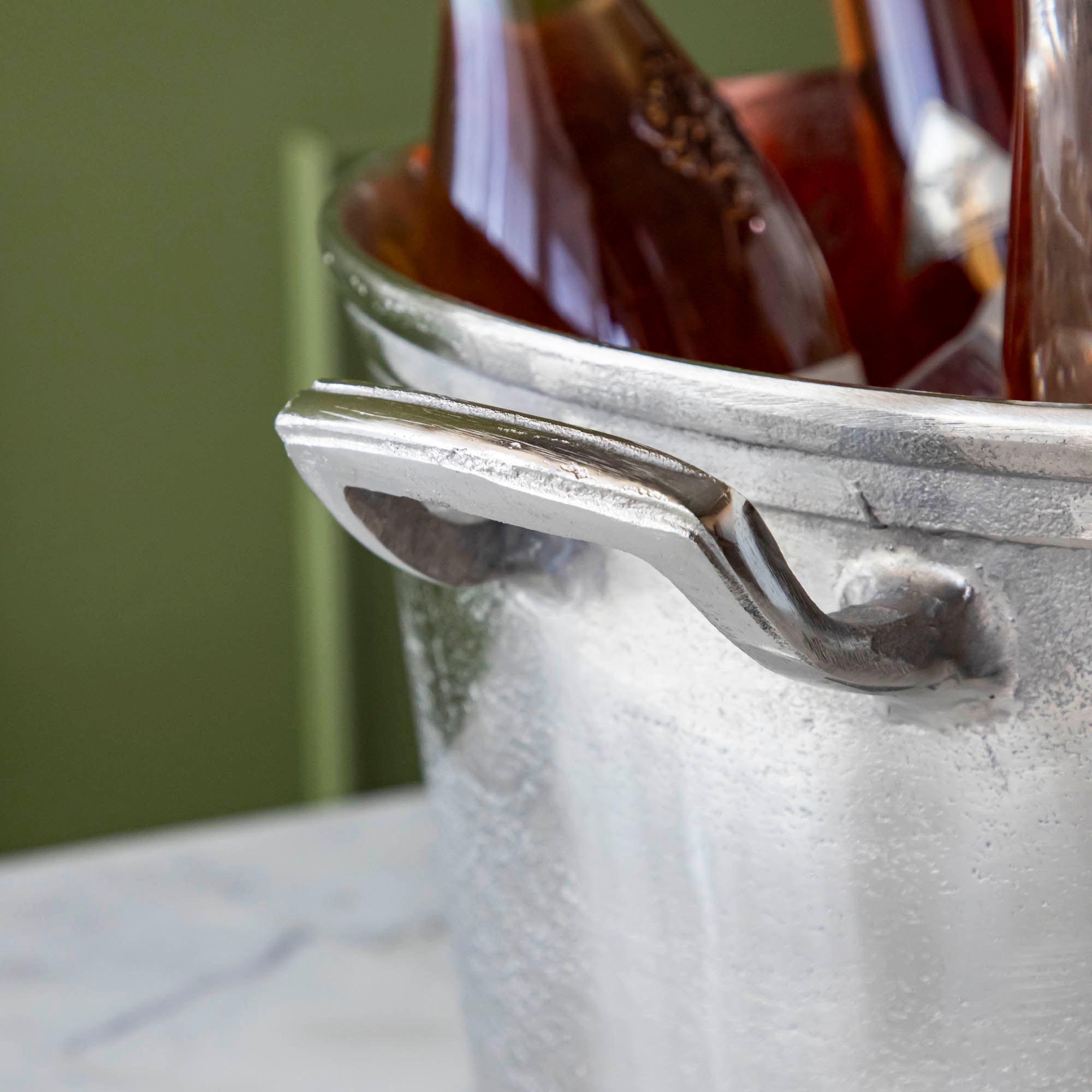 A close up of the  Raw Aluminum Handled Planter/Wine Cooler handle.