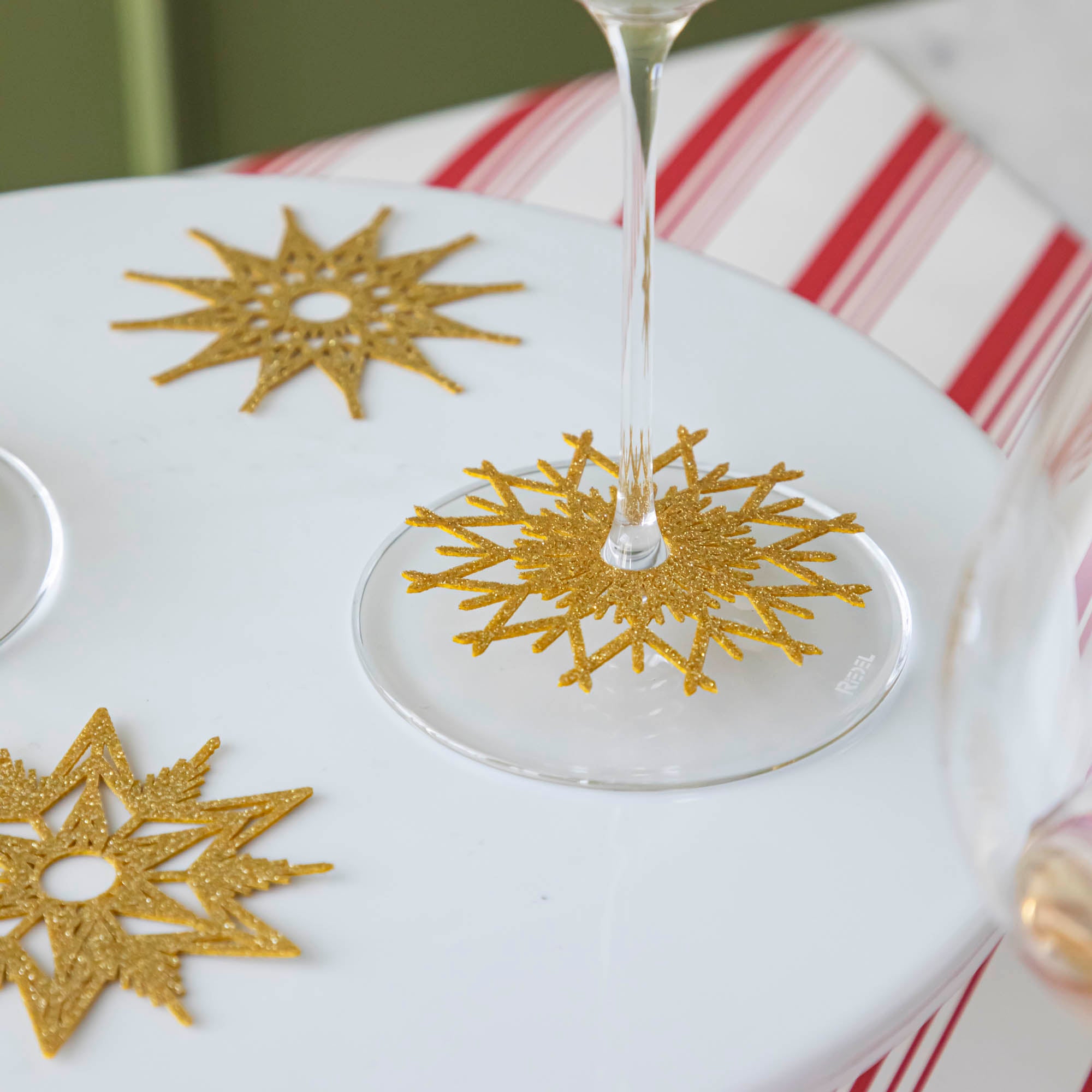 A Stemware Snowflake Collars on the base of a wine glass.