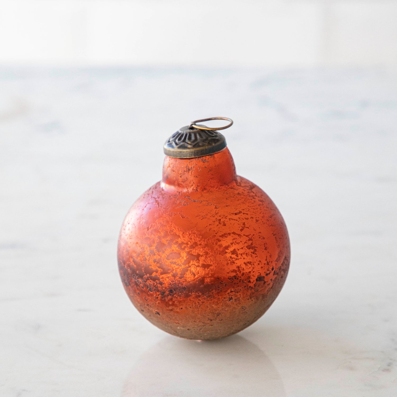 Orange Kugel Ornament on a white background