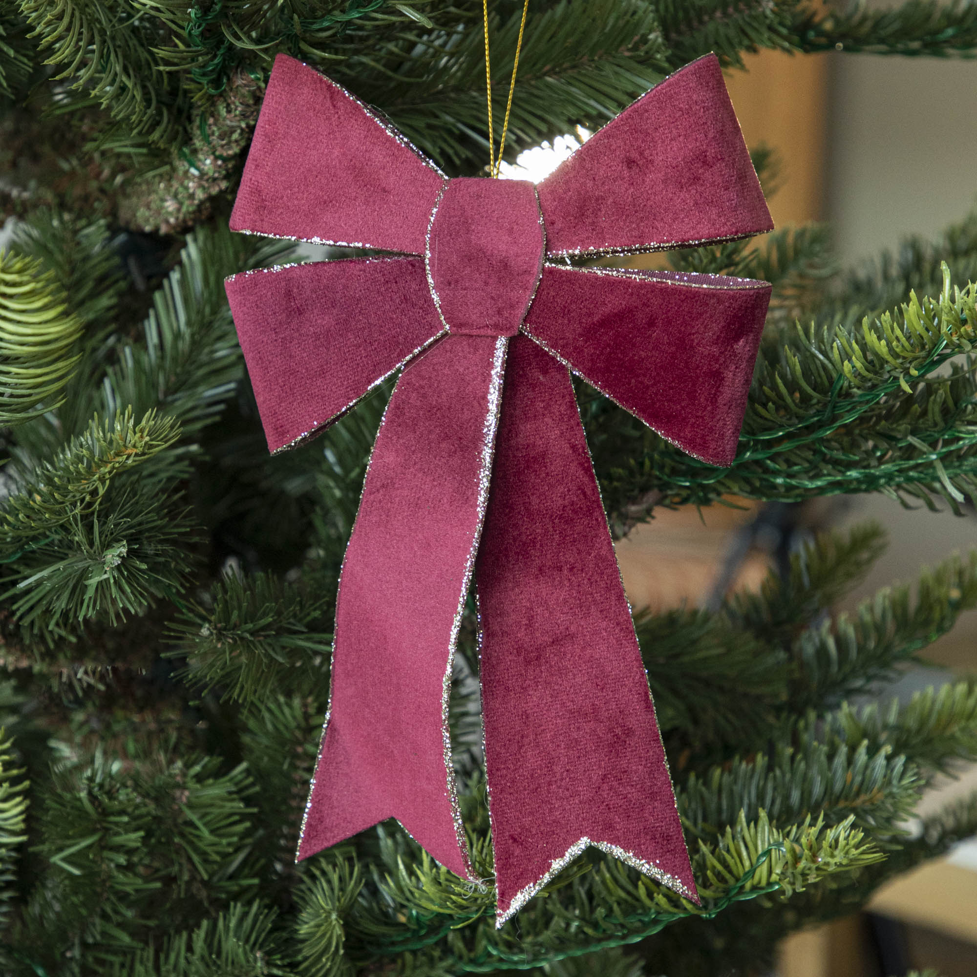 Burgundy Velvet Double Bow with silver glitter on edges hanging in tree