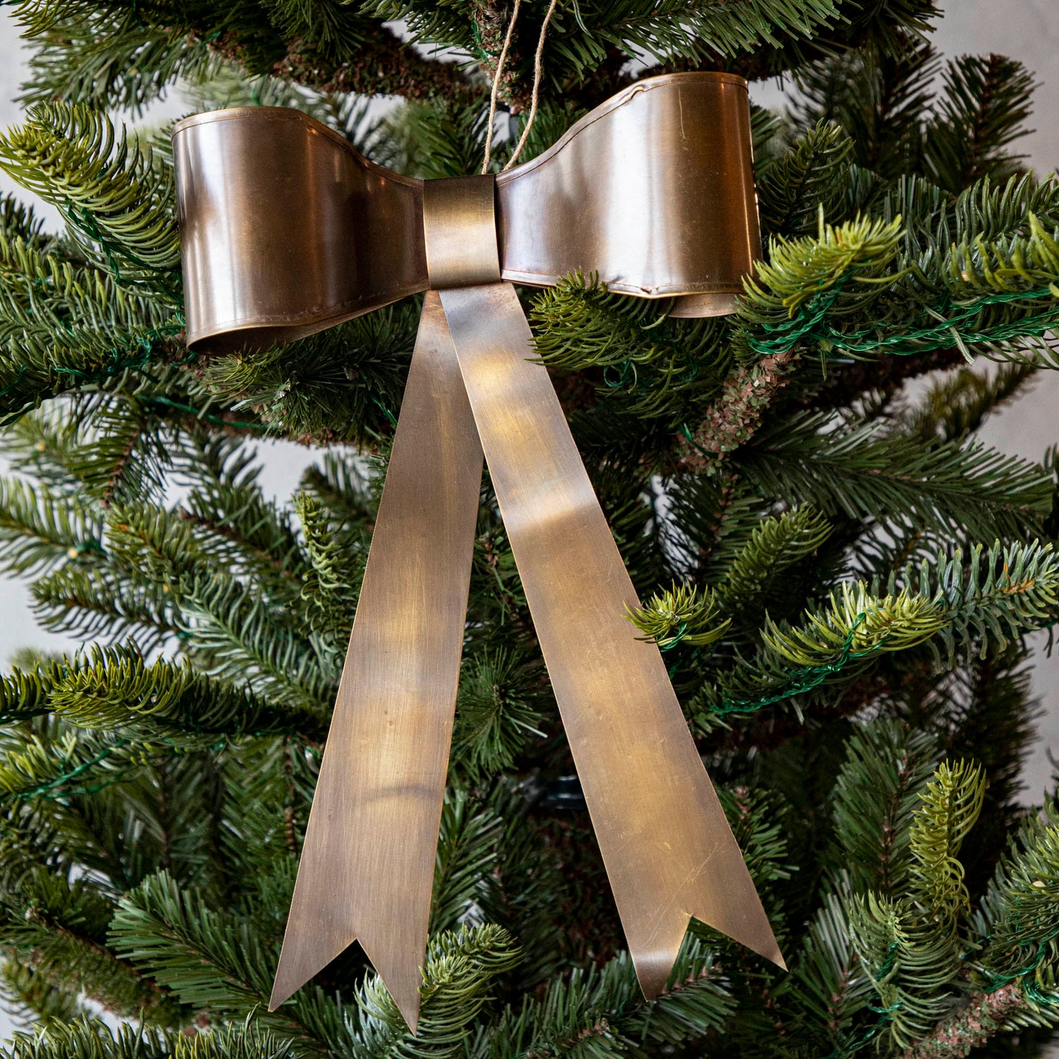 Single Brass Bow Ornament in Christmas Tree