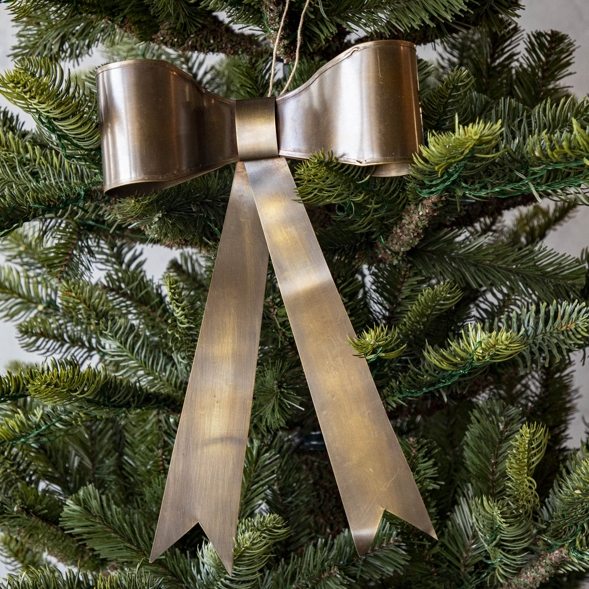 Single Brass Bow Ornament in Christmas Tree