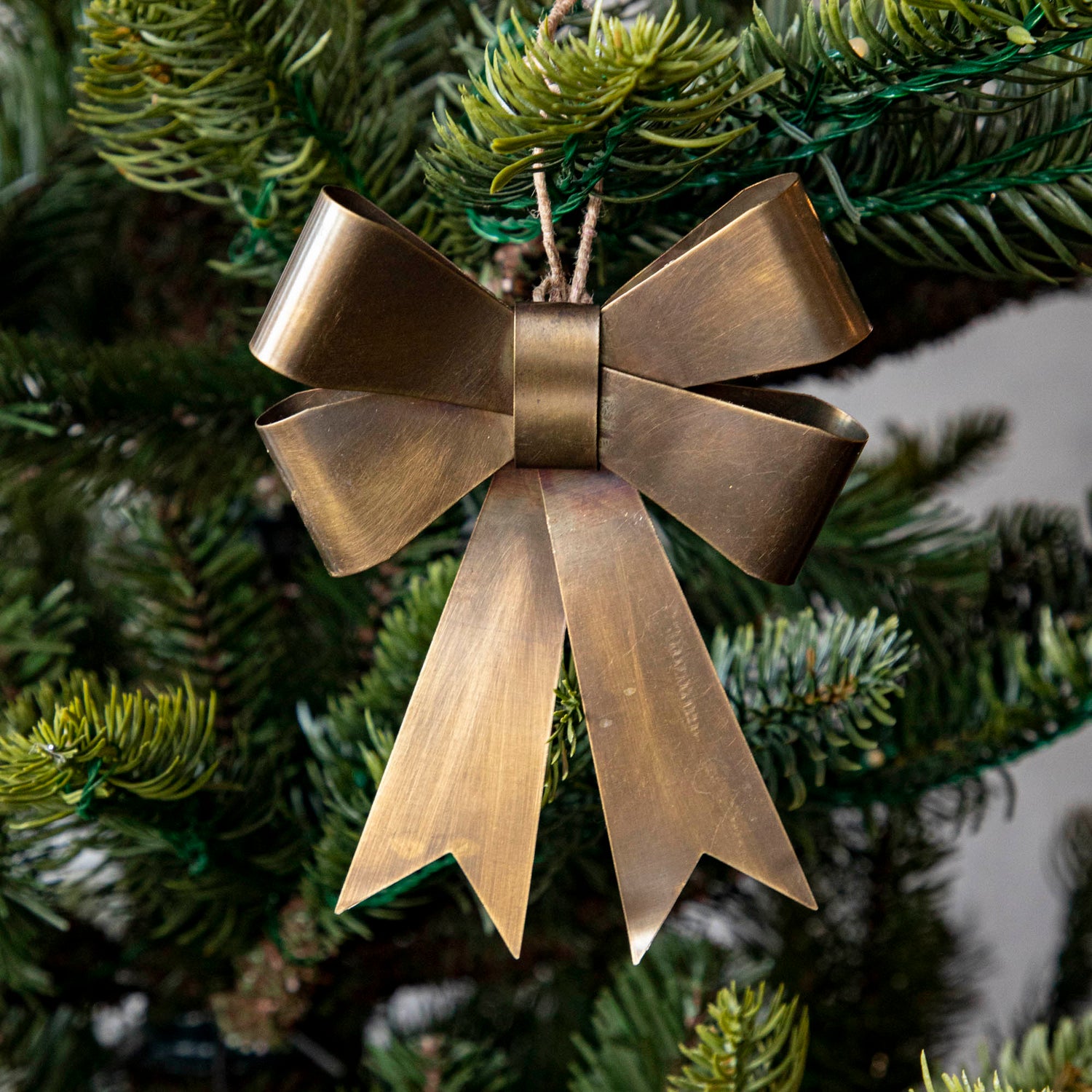 Double Brass Bow Ornament in Christmas Tree