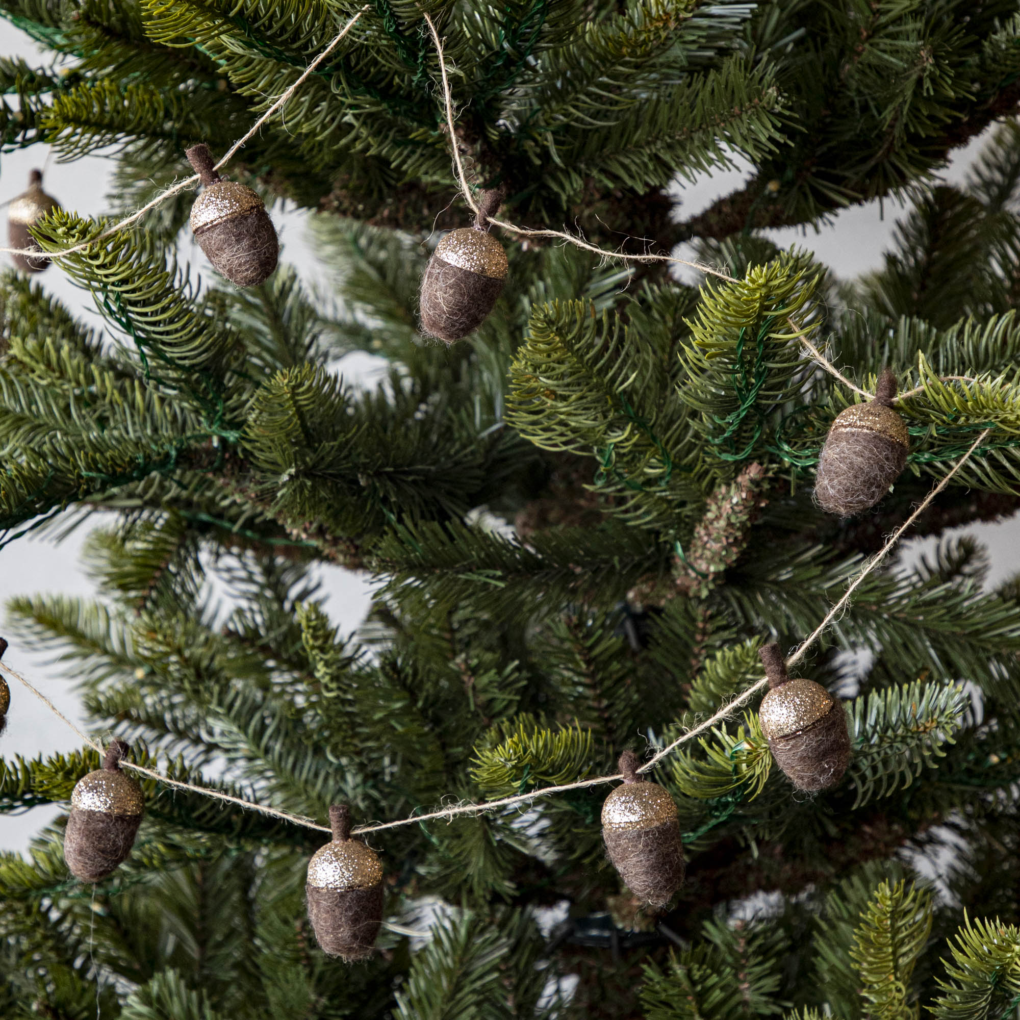 Woolen acorn garland strewn around a tree