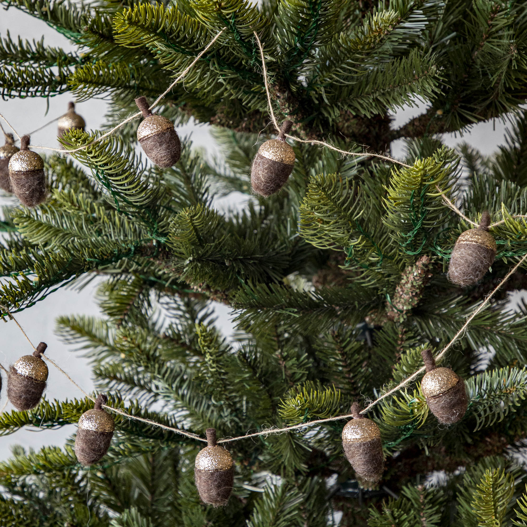 Woolen acorn garland strewn around a tree