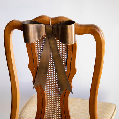 Single Brass Bow on back of chair