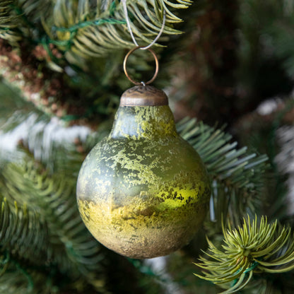 Green Kugel Ornament hanging in a tree