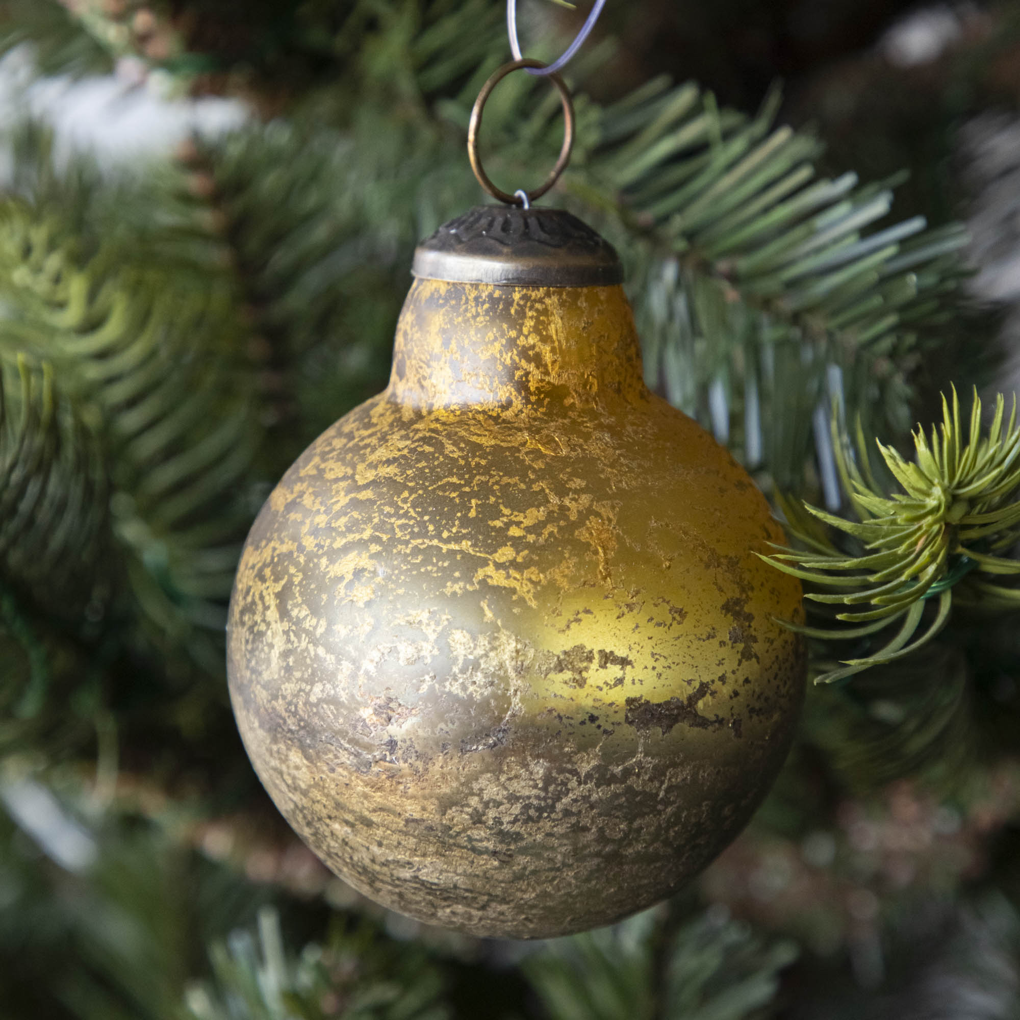 Gold Kugel Ornament hanging in a tree