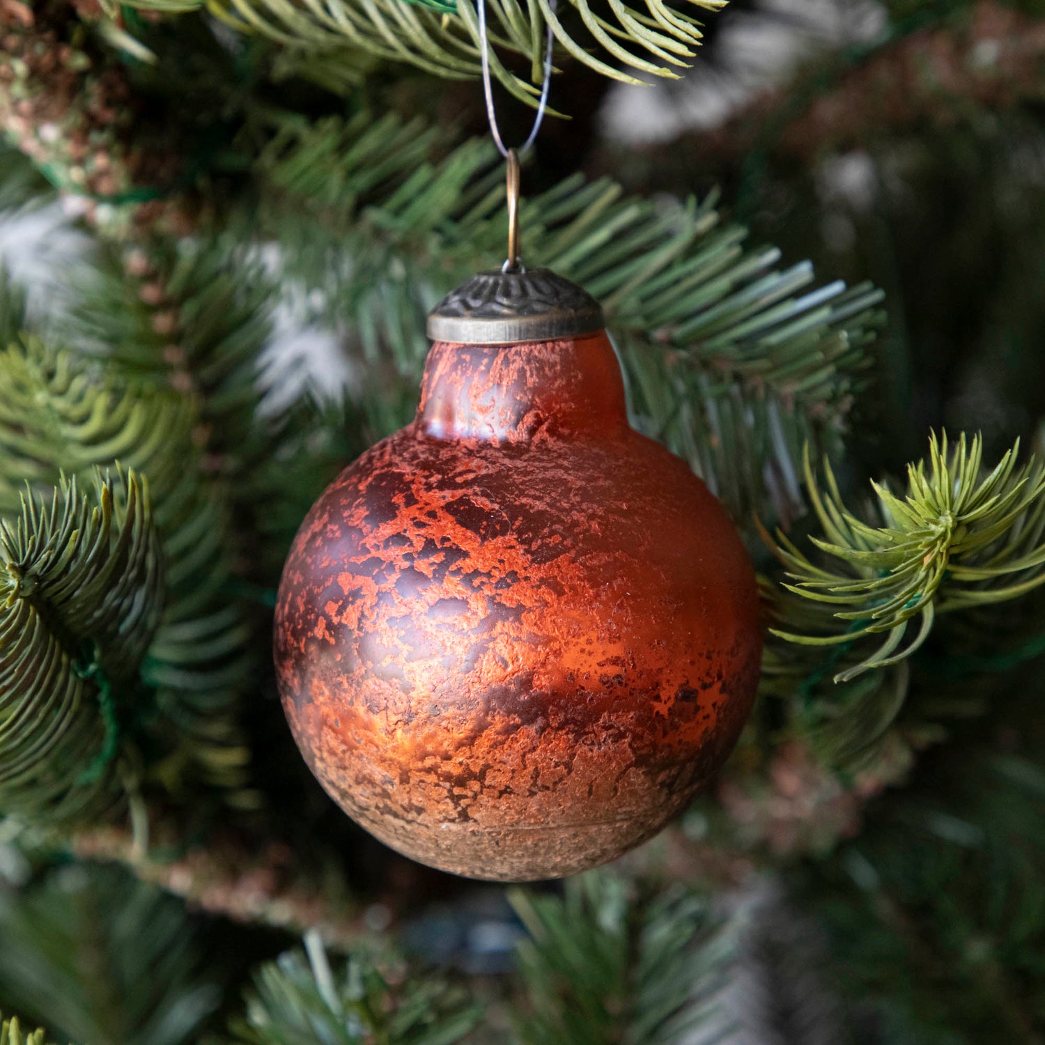 Orange Kugel Ornament hanging in a tree