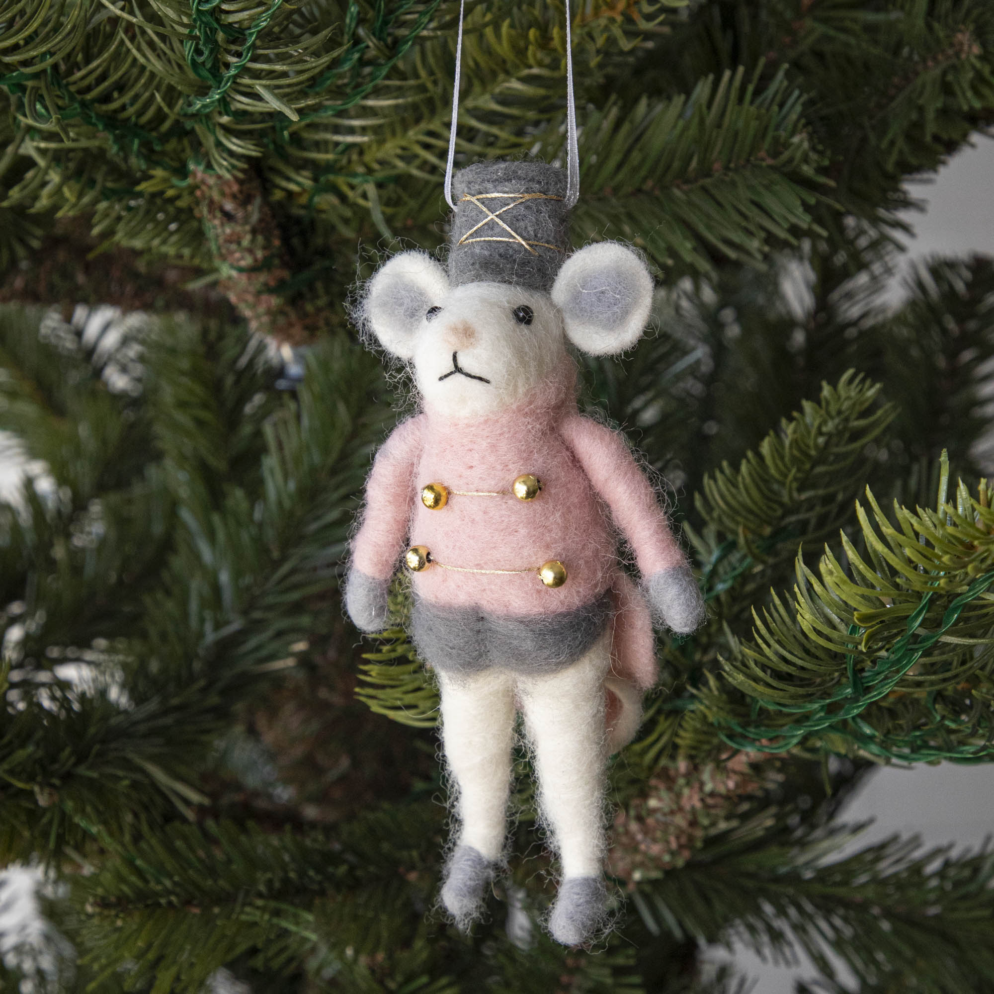 Felt Mouse Ornament with Pink band jacket on and a grey hat handing in a Christmas Tree