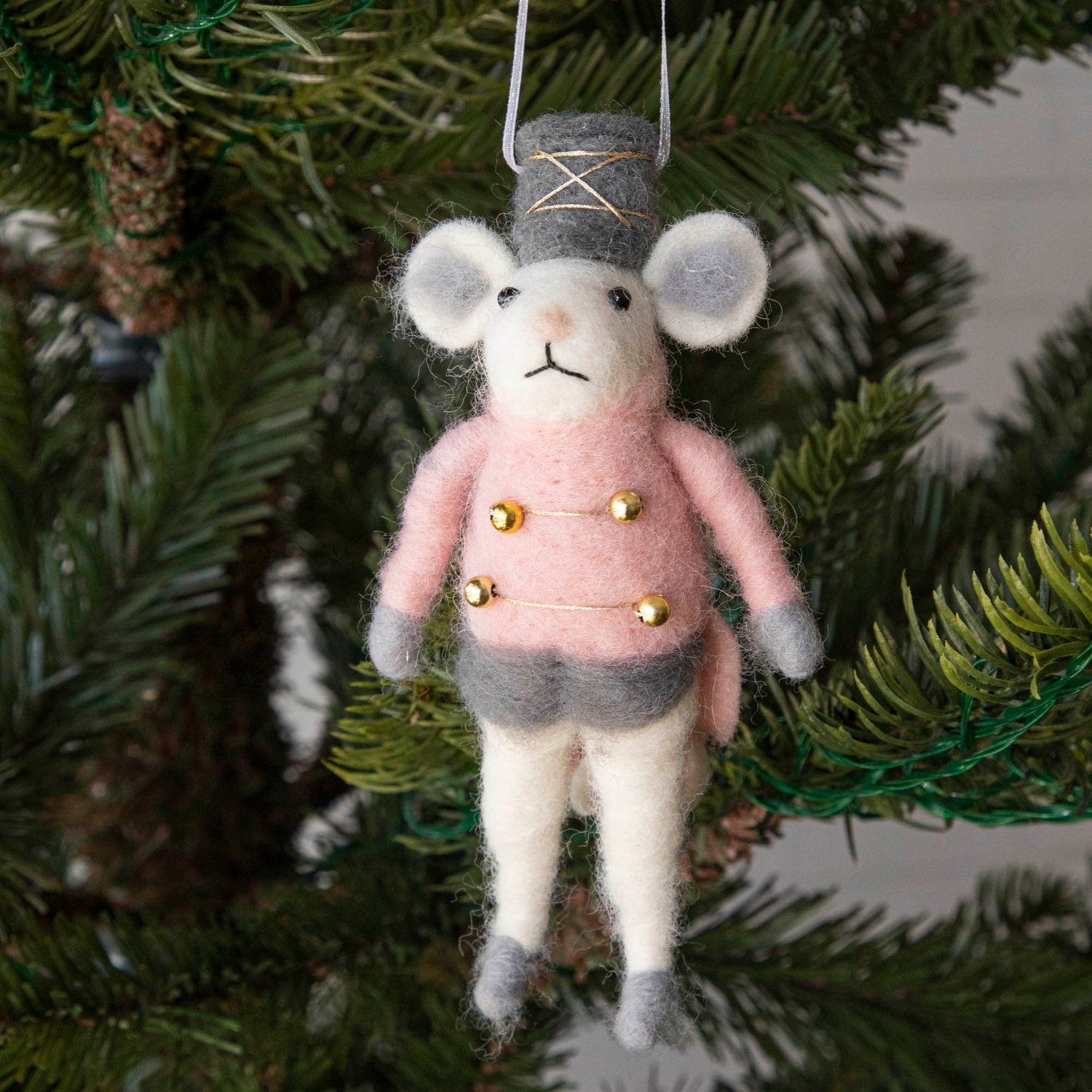 Felt Mouse Ornament with Pink band jacket on and a grey hat handing in a Christmas Tree