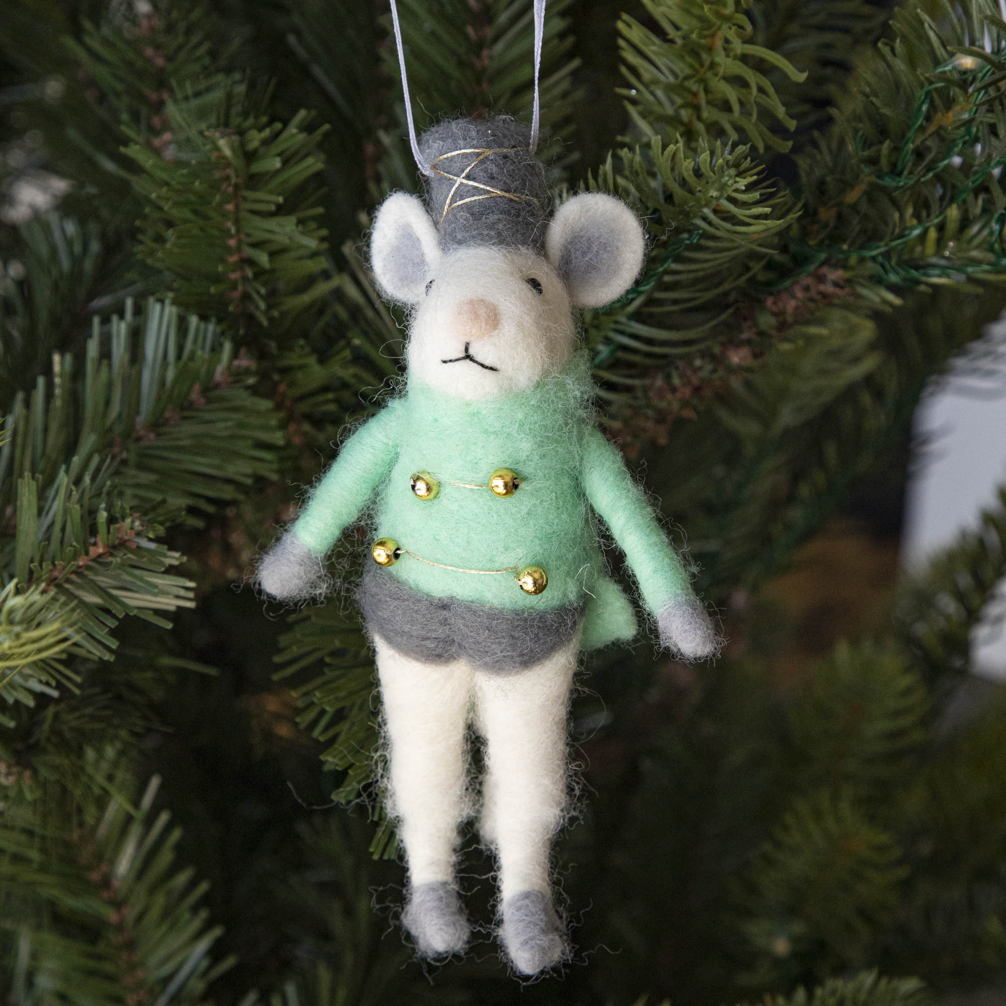 Felt Mouse Ornament with green band jacket on and a grey hat handing in a Christmas Tree