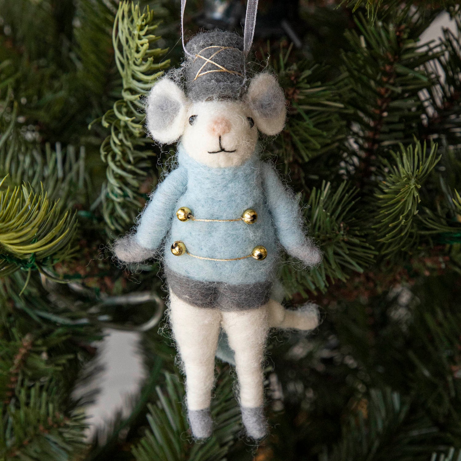 Felt Mouse Ornament with blue band jacket on and a grey hat handing in a Christmas Tree