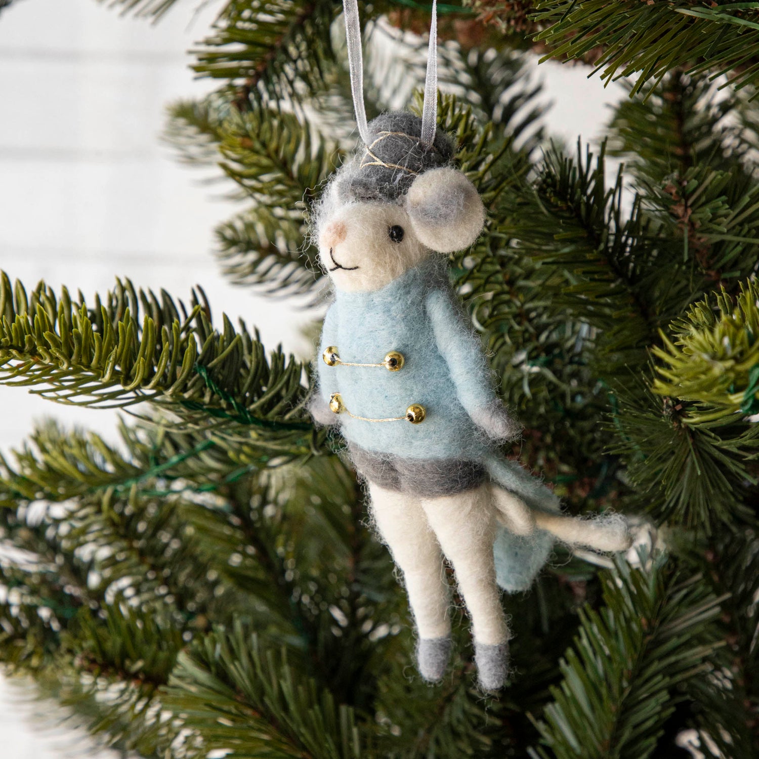 Felt Mouse Ornament with blue band jacket on and a grey hat handing in a Christmas Tree