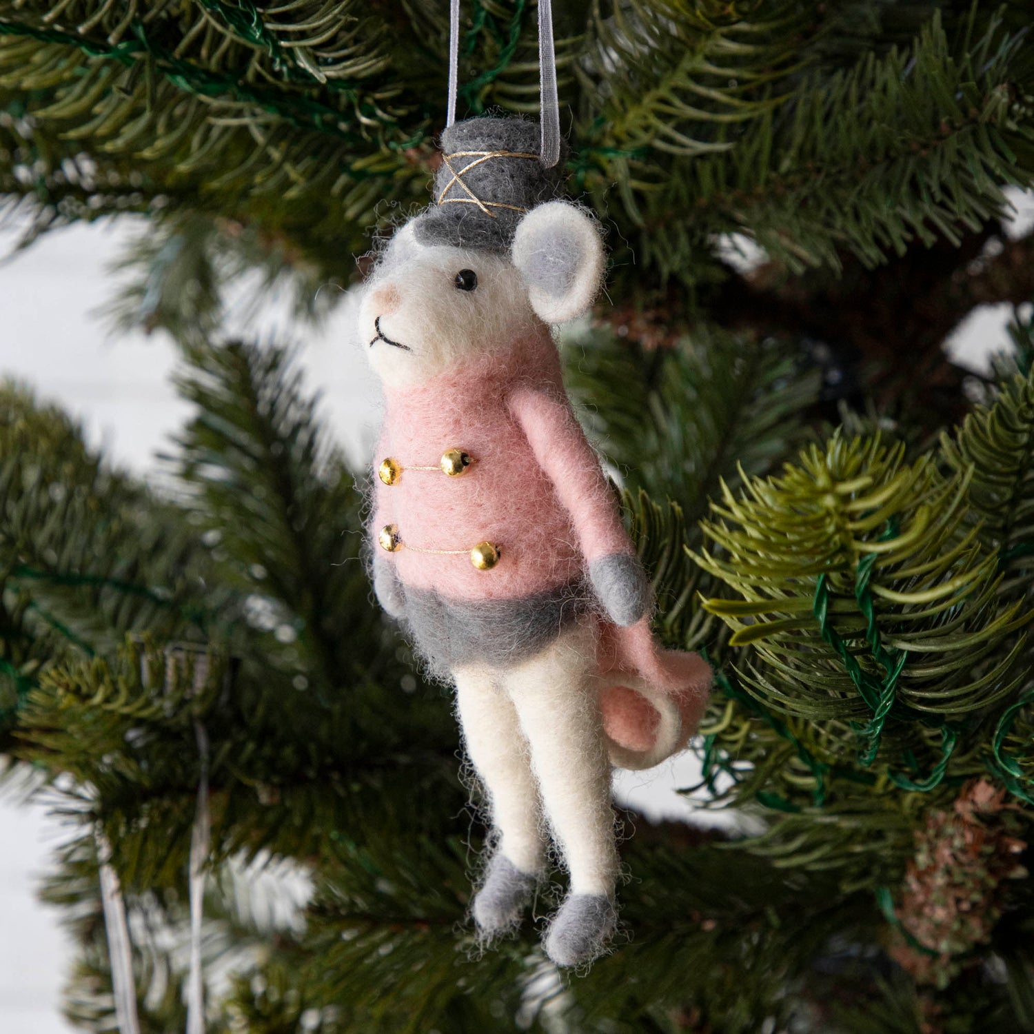 Felt Mouse Ornament with Pink band jacket on and a grey hat handing in a Christmas Tree