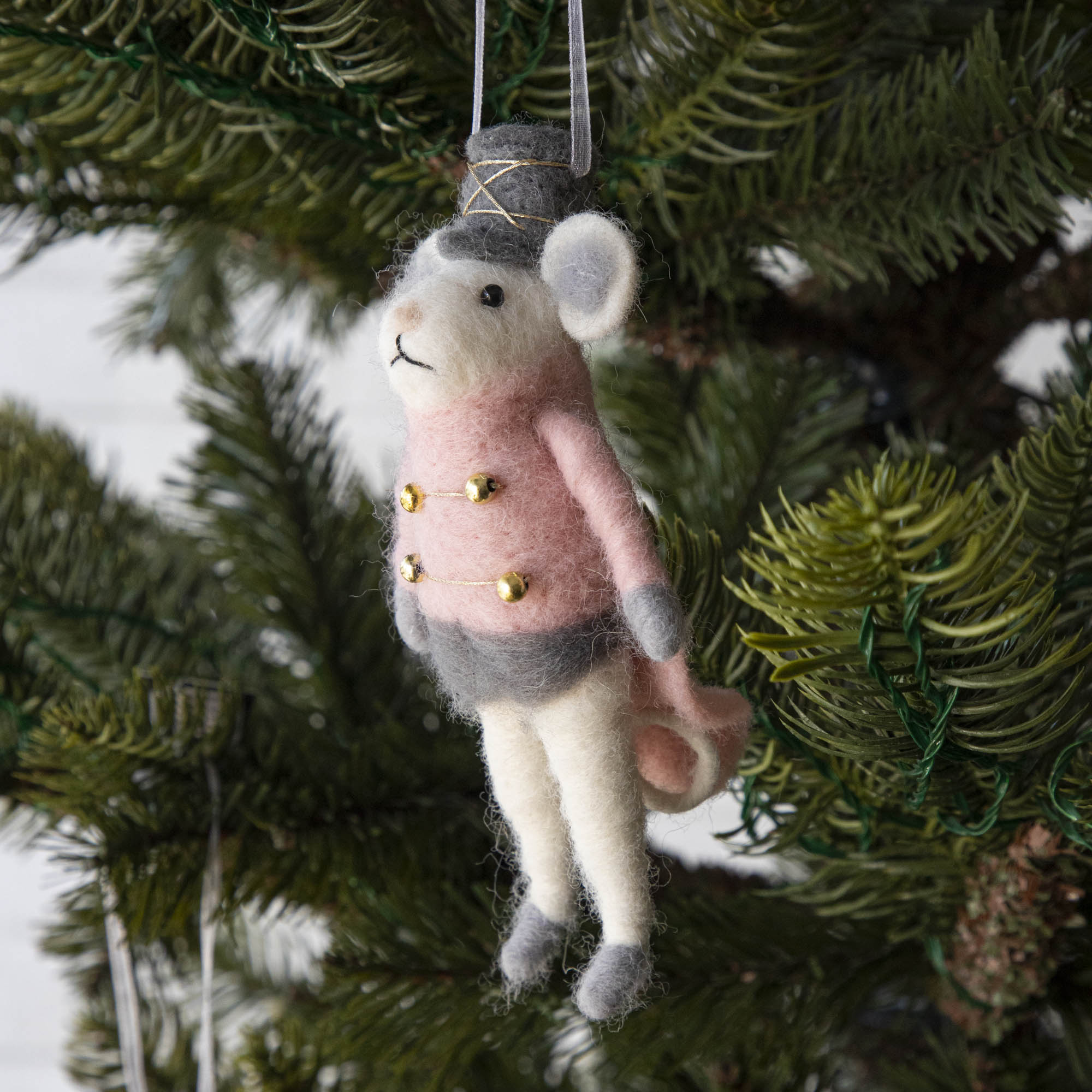 Felt Mouse Ornament with Pink band jacket on and a grey hat handing in a Christmas Tree