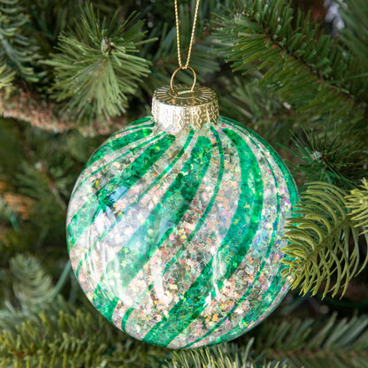 Teal &amp; White Candy Striped Glitter ball ornament hanging in a tree