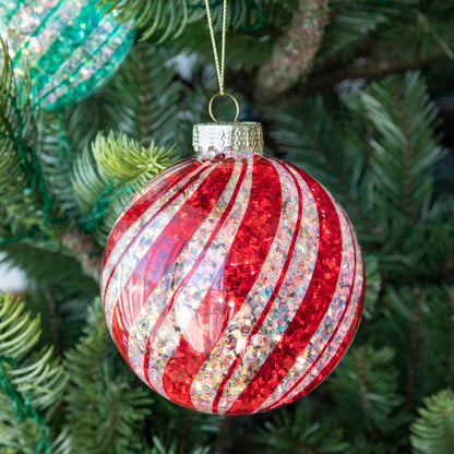 Red &amp; White Candy Striped Glitter ball ornament hanging in a tree