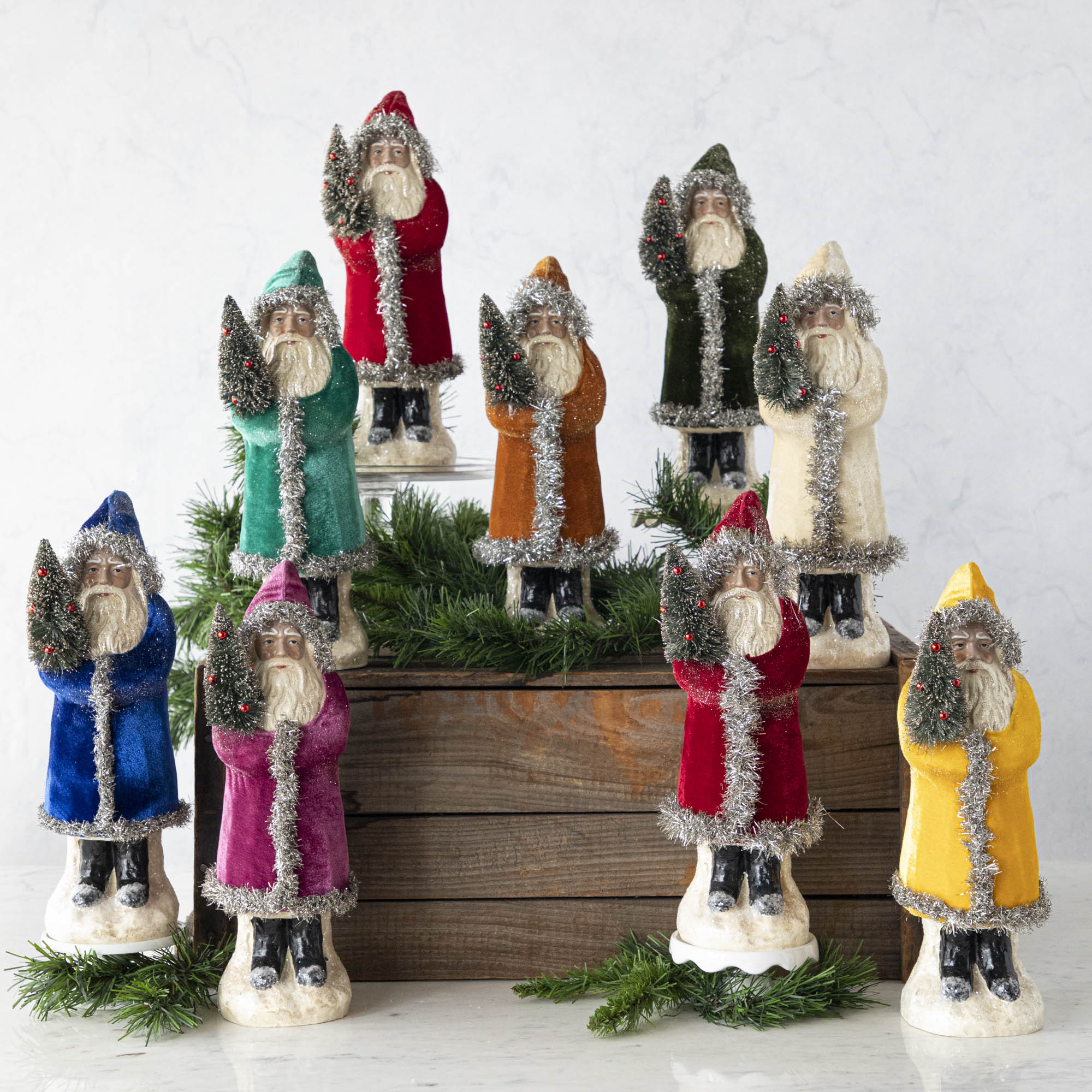 Nine assorted 12&quot; Velvet Belsnickle figurines with a velvet robe adorned with tinsel trimming and glitter, holding a tree.